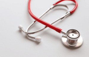 A stethoscope sitting on a white table top.