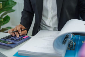 Stack of binder file folder on table in business modern office. on wooden desk in large modern office