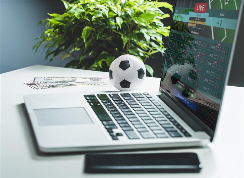 A desk environment with a soccer ball sitting on it.