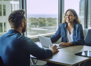 Performance review examples, Woman manager conducting a performance review in her office with large windows