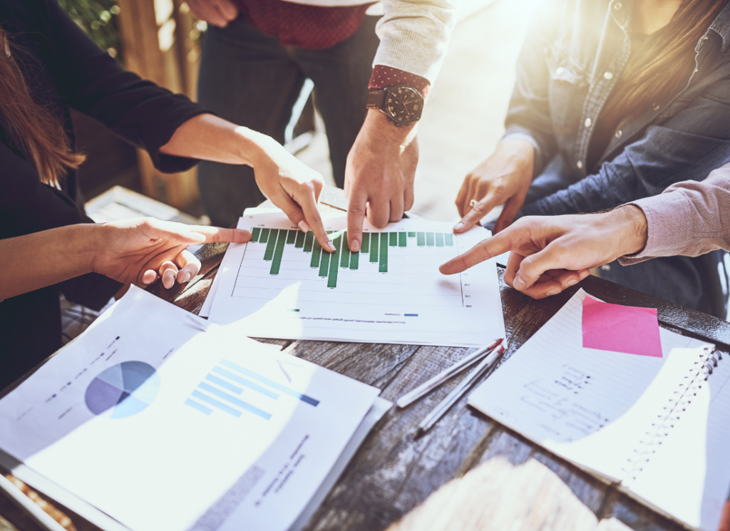 A team of nonprofit accountant in a meeting reviewing financial reports.