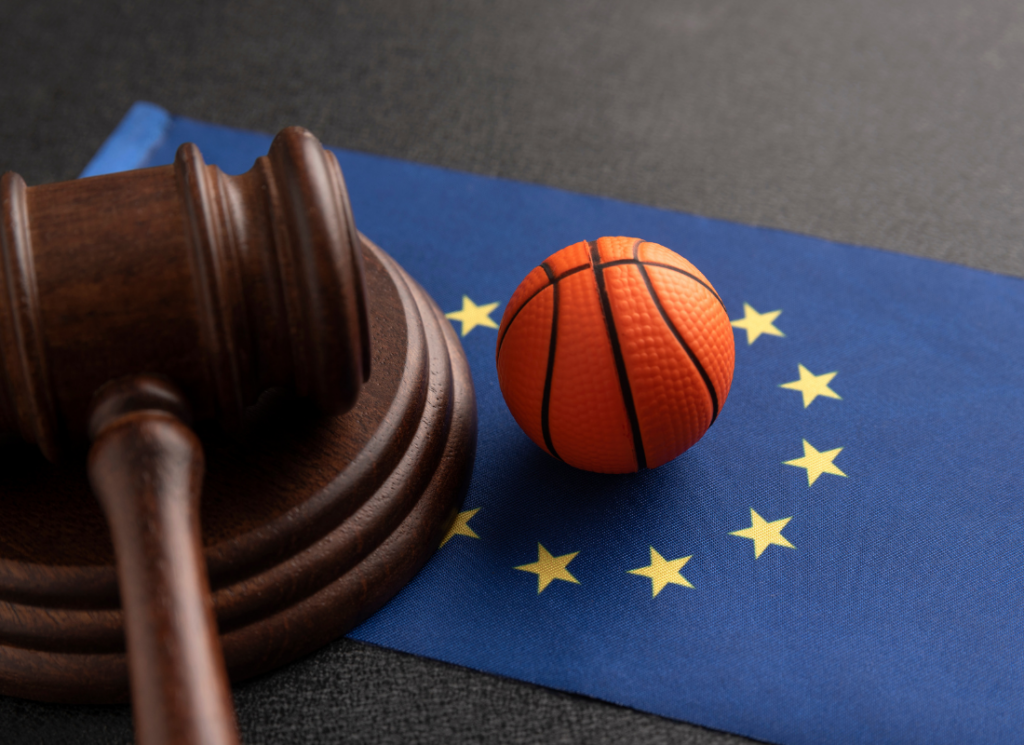 A judge's gavel and a small basketball rest on a blue flag with yellow stars, symbolizing the intersection of law, sports, and strategic decision-making.